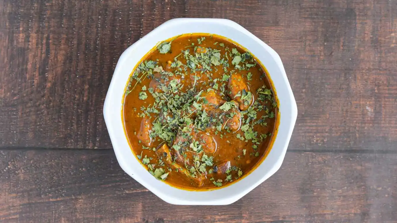 Goat Curry — bone-in slow-cooked goat in aromatic curry at Singh Sweet Mahal, Winnipeg